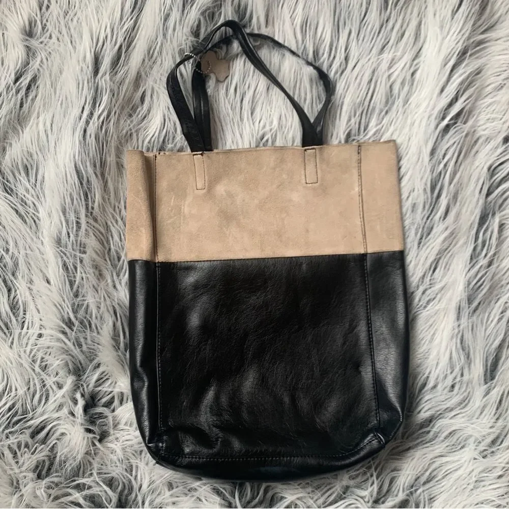 Soft, color-block Shopper Tote with concealed magnetic fastener at top. Unlined.